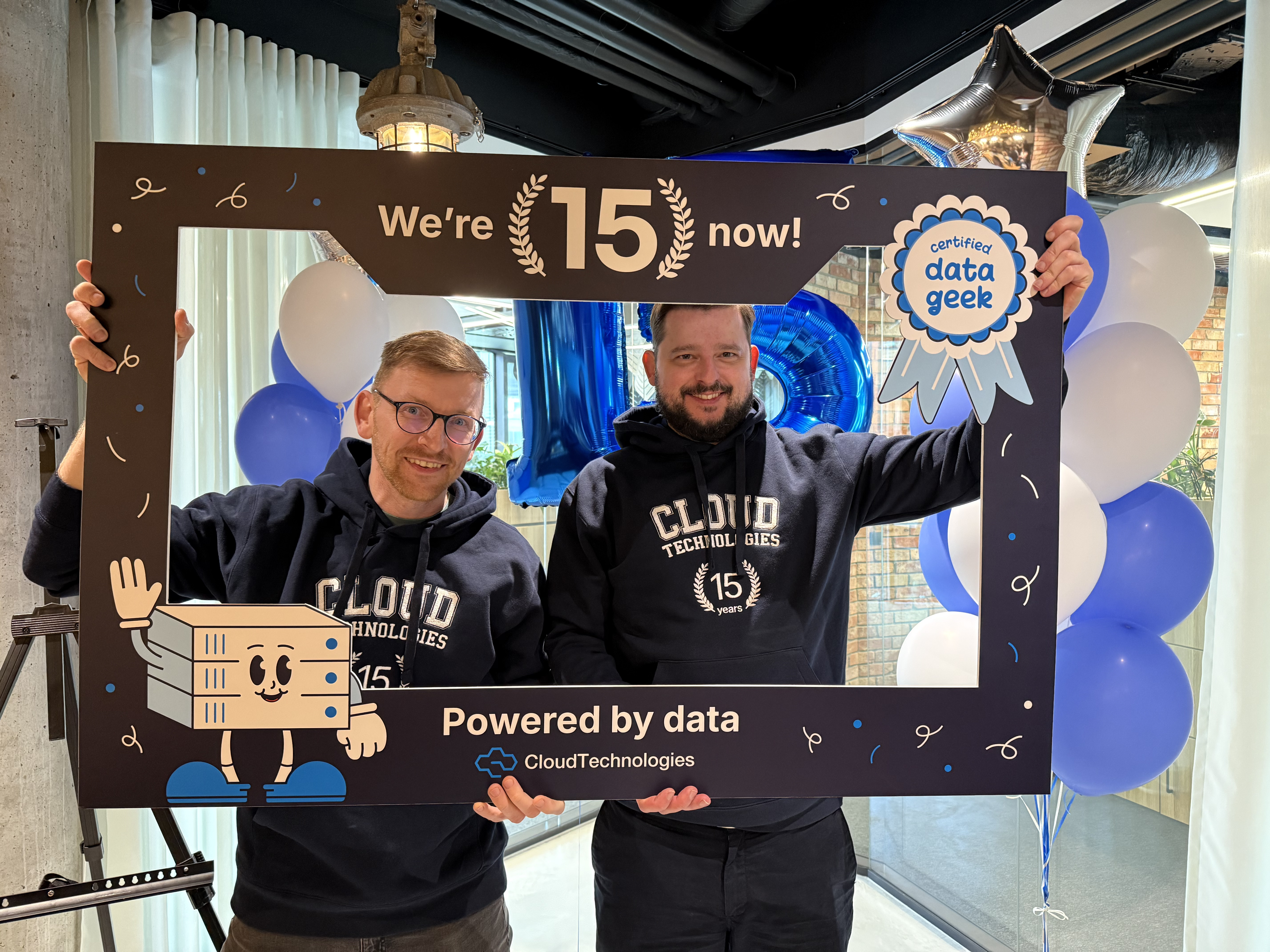 15 years photobooth frame with team in Cloud Technologies hoodies