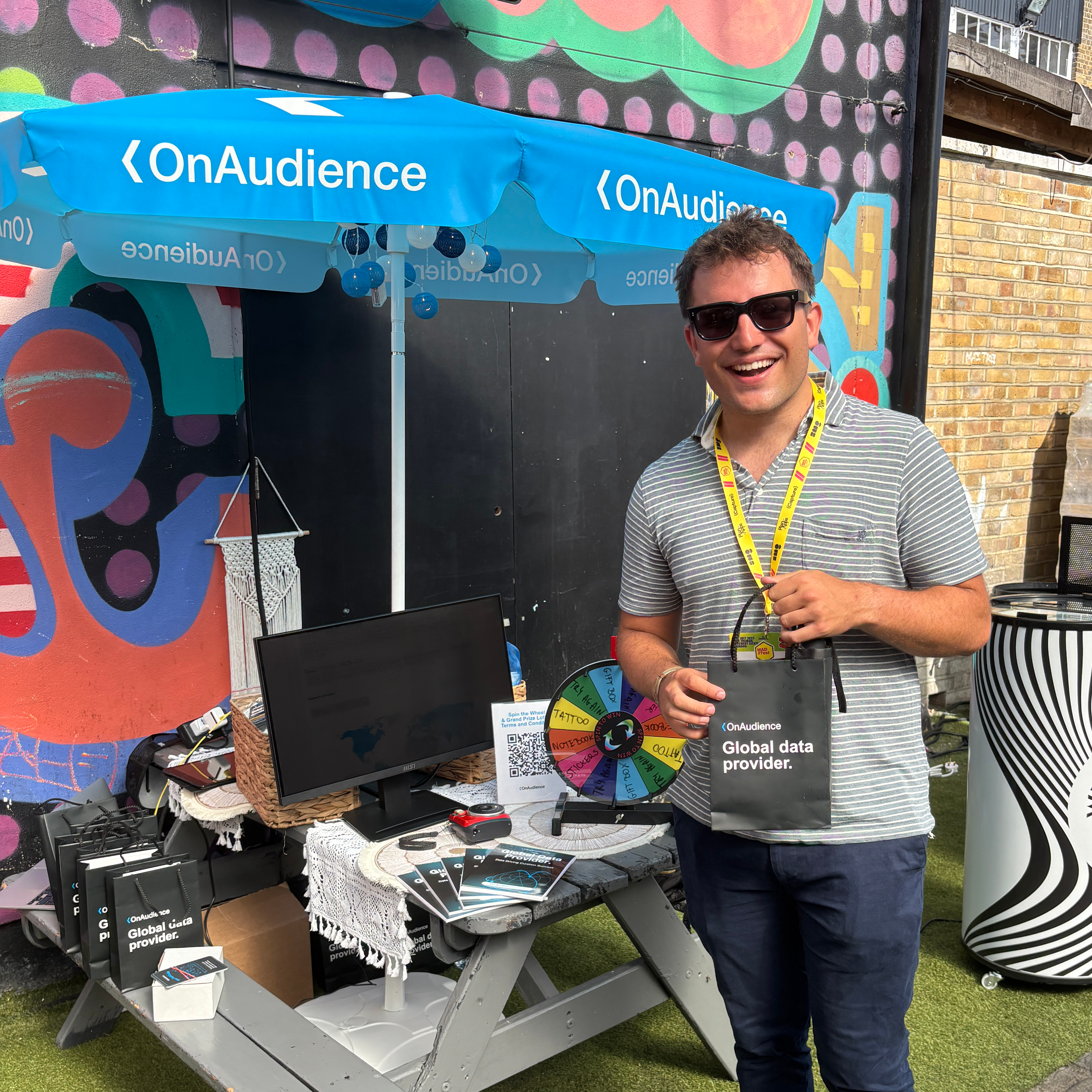 OnAudience booth at MAD//Fest with spin-to-win wheel and branded giveaway bags